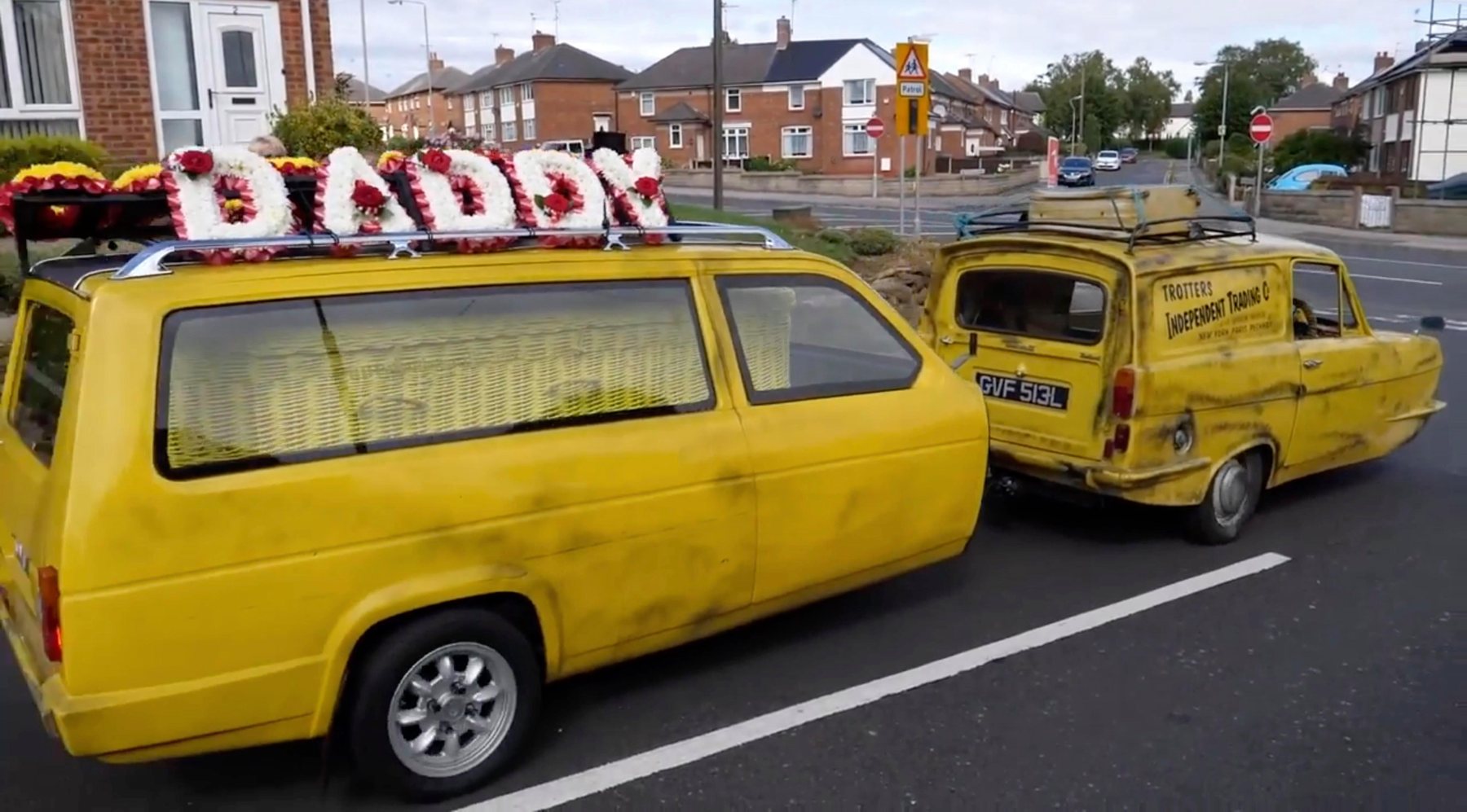 Yellow Reliant Regal hearses carrying a DADDY floral tribute